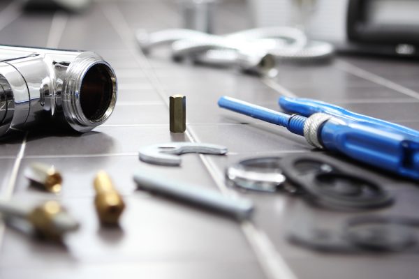 plumber at work in a bathroom, plumbing repair service, assemble and install concept